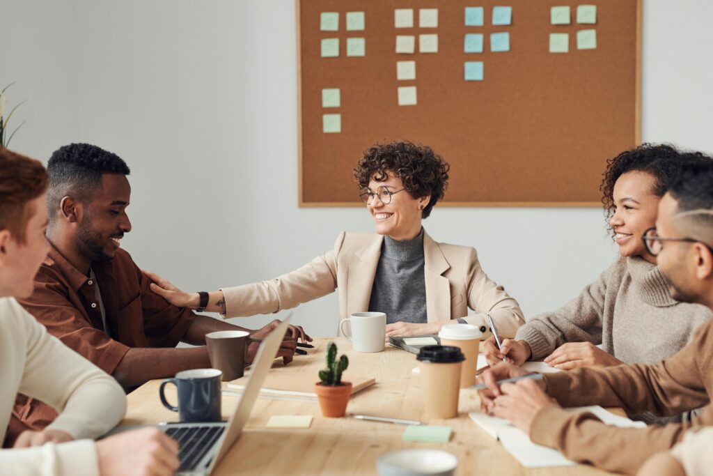 pexels photo 3184285 3184285 Business professionals engaged in a collaborative meeting in a modern office setting, sharing ideas and smiling.
