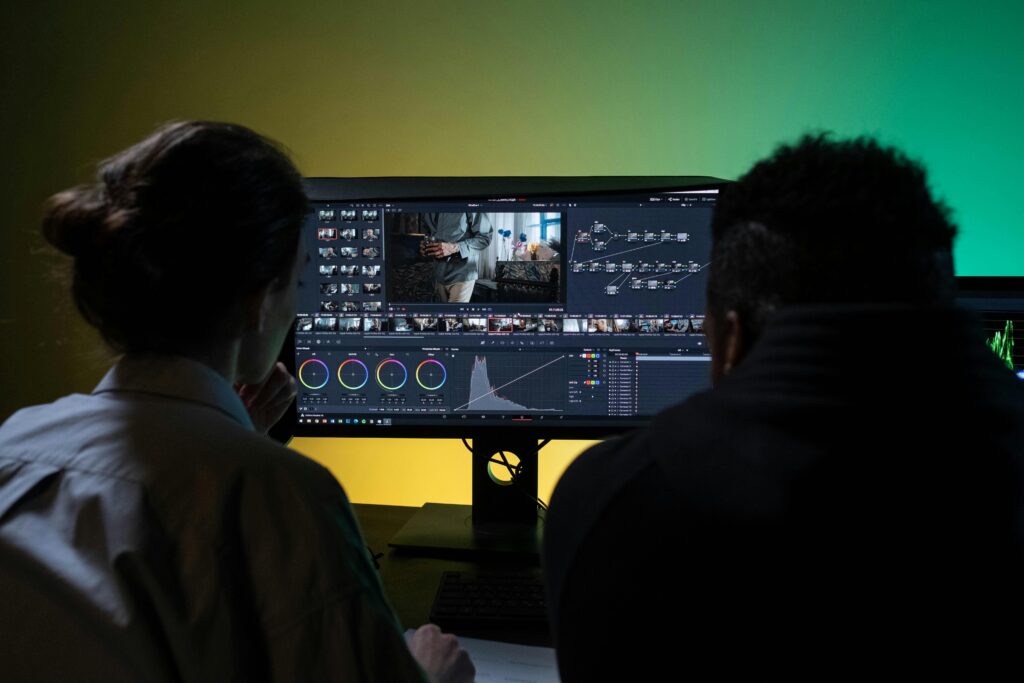 pexels photo 8102680 8102680 Team of two professionals video editing in a modern setup with dual monitors.