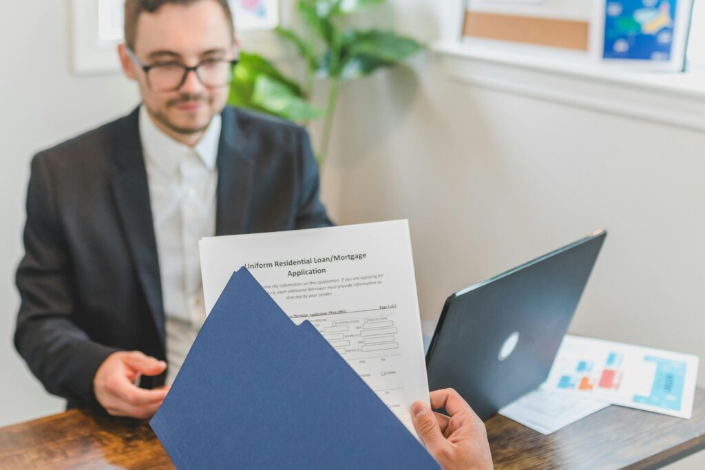 pexels photo 8292879 8292879 Mortgage broker and client discussing loan application with documents on table.