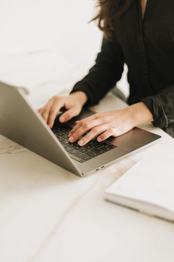 pexels-photo-30612694-30612694 Woman typing on laptop in bright, modern workspace. Ideal for business settings.